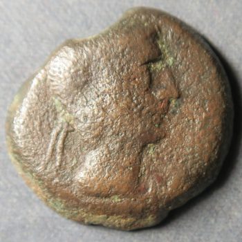 Male had on ancient bronze coin