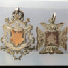 Pair of silver fob medal prizes H. H. G. C. 1900, 1902 to Anne Collington Golf Club prizes