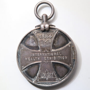  Circular silver medal with suspension loop to commemorate the International Health Exhibition held in London in 1884