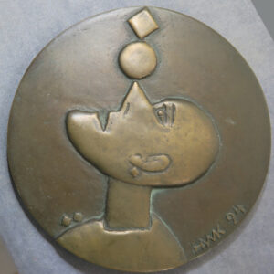 Human balancing a circle and square on a triangular nose, bronze medal HWK 94
