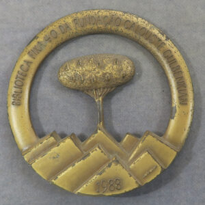 tree growing out of books brass medal